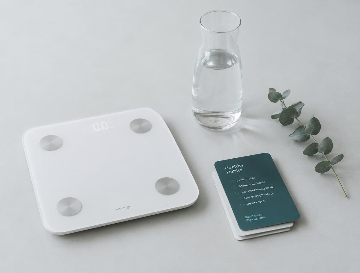 Body composition scale with water and a healthy habits card